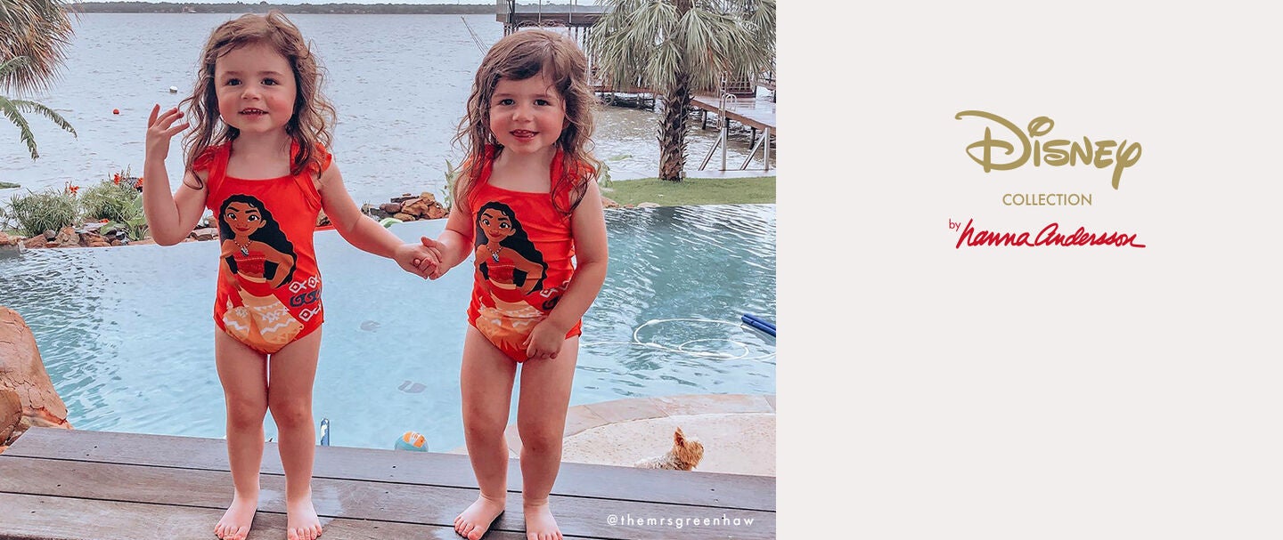 Twin sisters in matching Disney swimsuits Twin sisters in matching Disney swimsuits