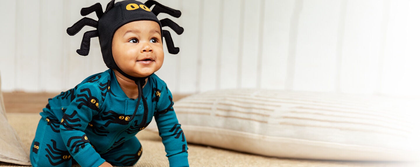 Baby in blue spider pattern pajamas Baby in blue spider pattern pajamas