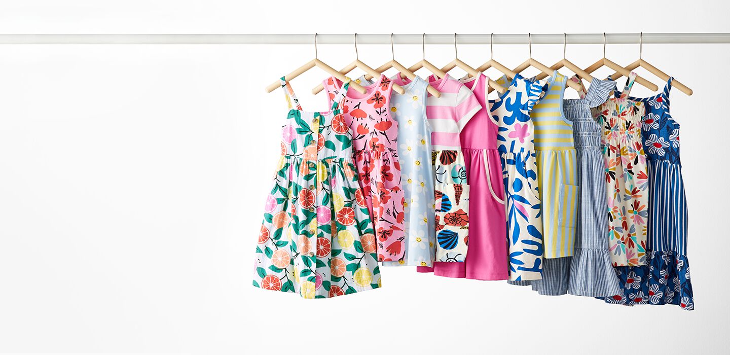 multi printed summer dresses on hangers. shop now.