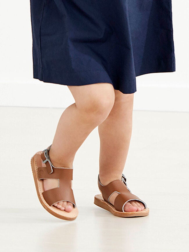 image of baby in blue dress and sandles