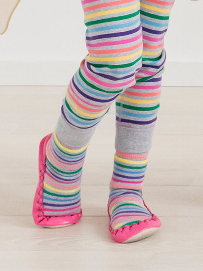 a kids wearing pink moccasins