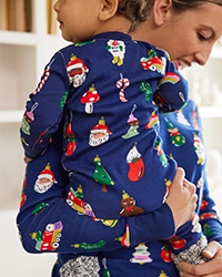 mom holding baby wearing matching family pajamas