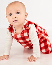 baby in red plaid outfit