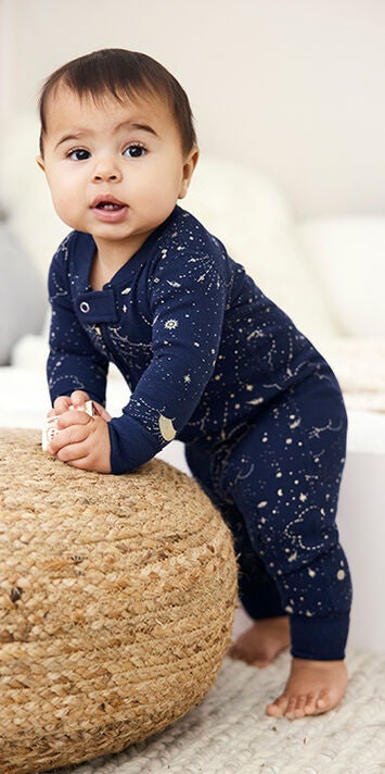Baby in stary print footless sleeper