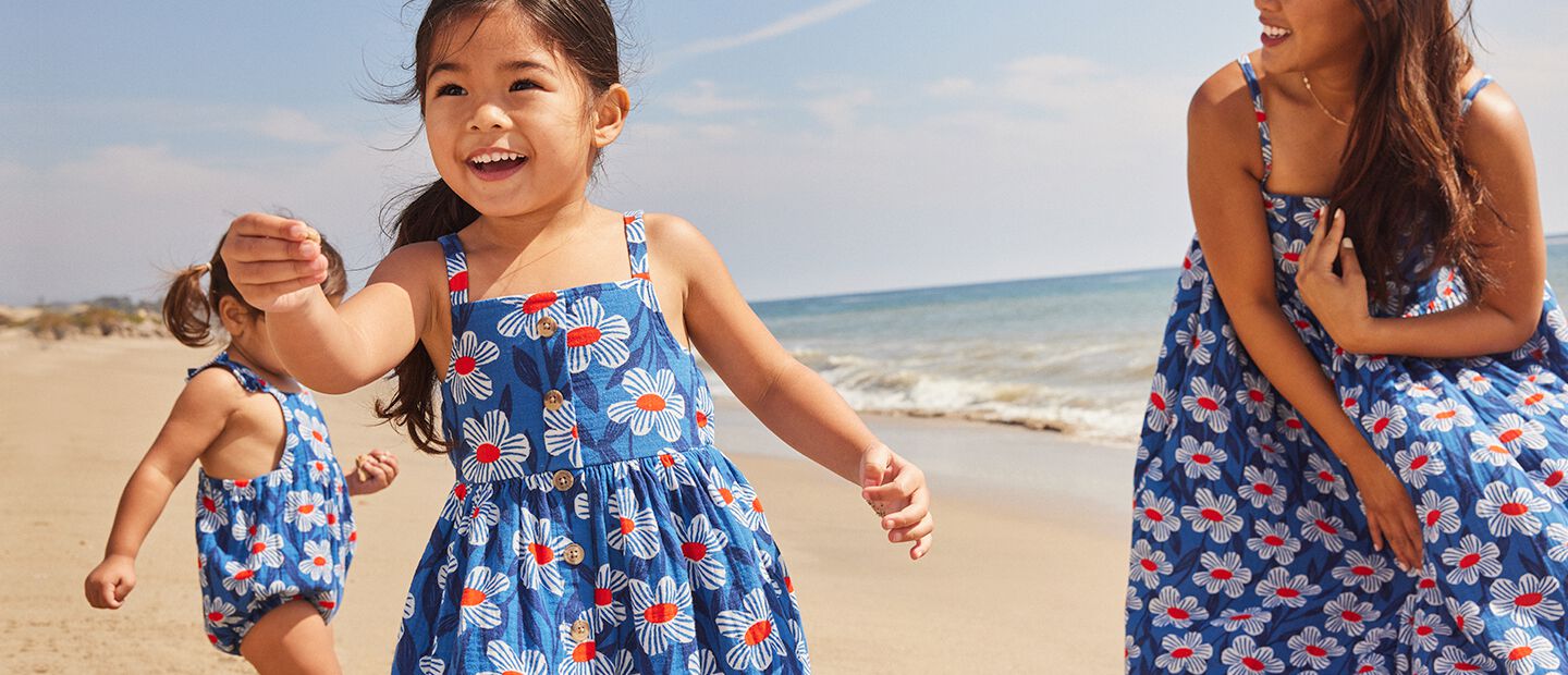 girls holding hands wearing different spring dresses