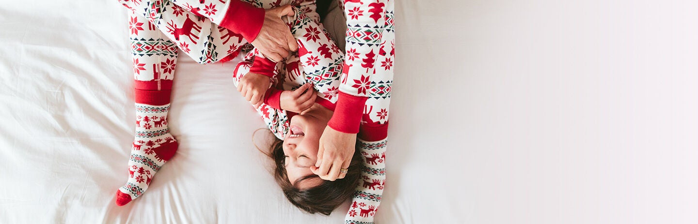 Mom and kids playing in matching Dear Deer pajamas Mom and kids playing in matching Dear Deer pajamas