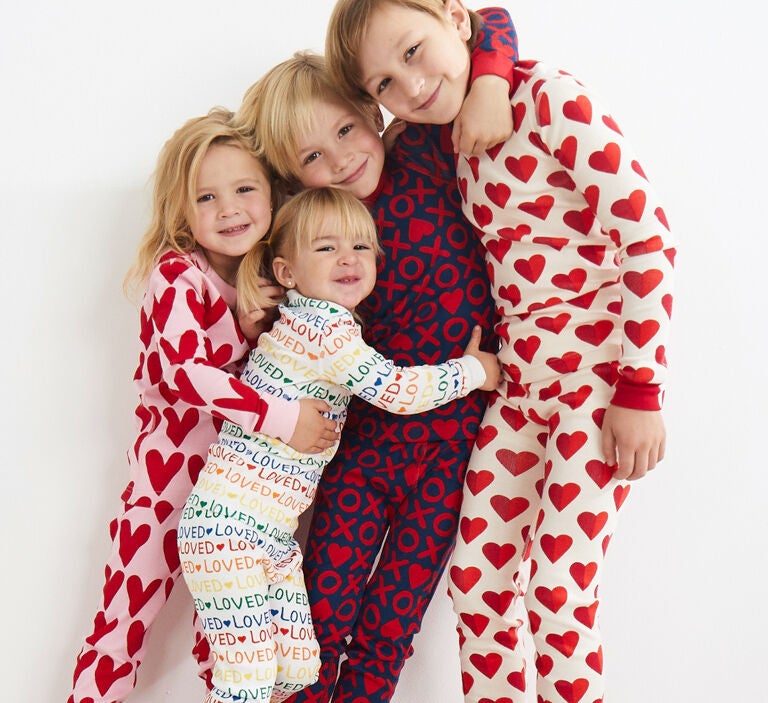 Siblings wearing various valentines pajamas