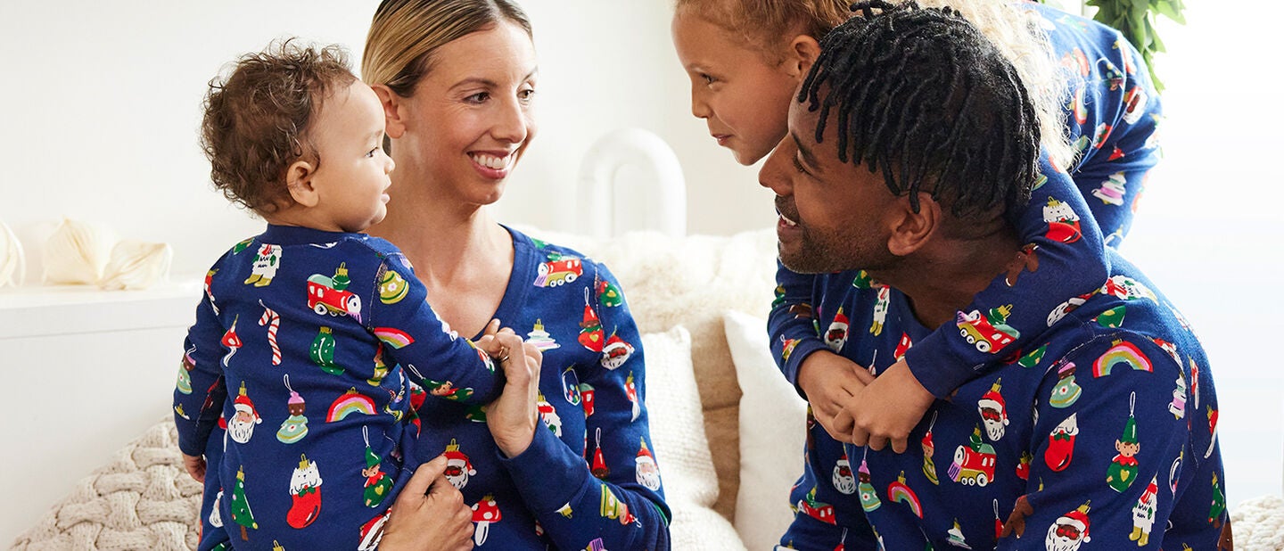 family in matching holiday print pajamas
