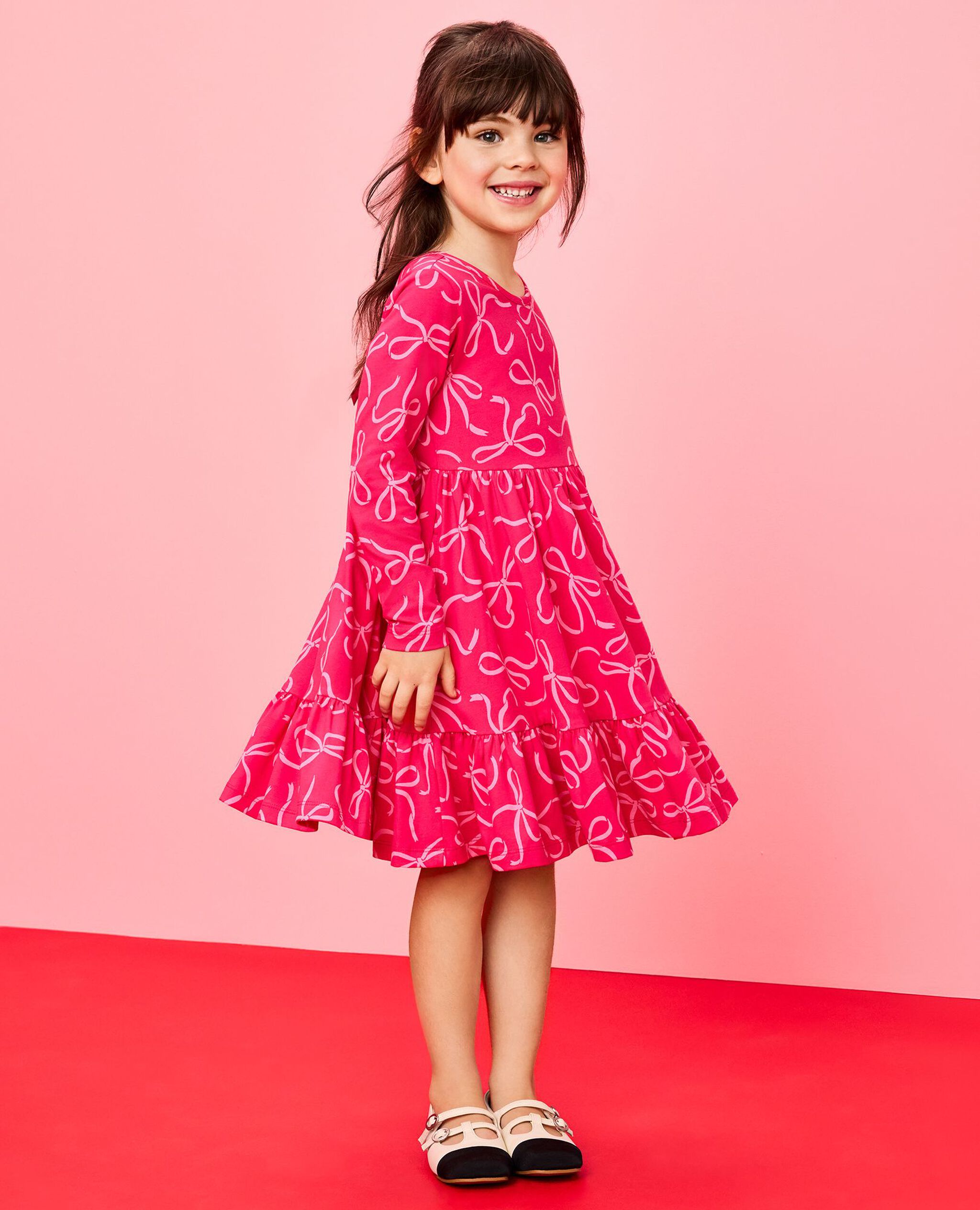 Long Sleeve Ruffle Skater Dress with Pockets in Bows on Beetroot Pink - main