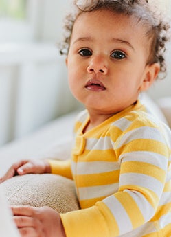 baby in yellow stripe sleeper