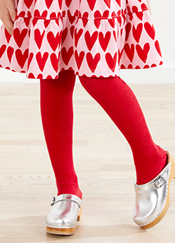 girl in hearts dress with red tights
