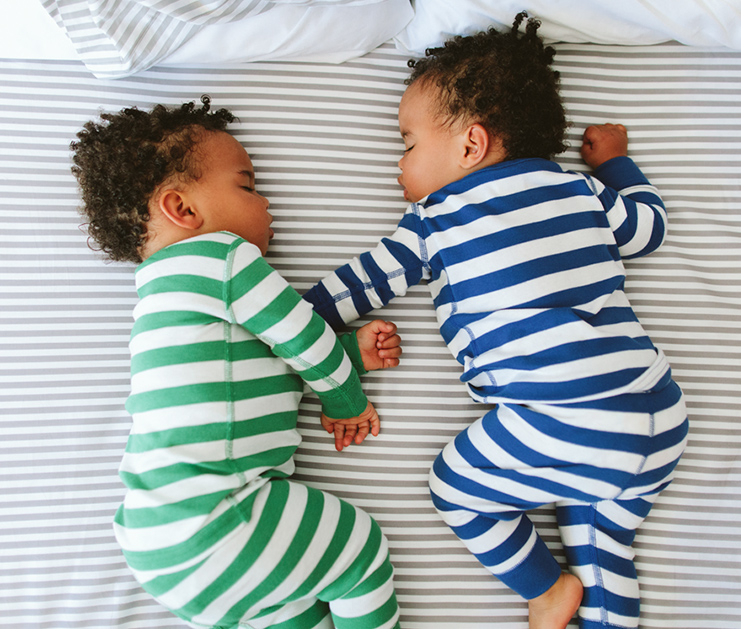 Image of infants sleeping in Hanna Andersson pajamas.