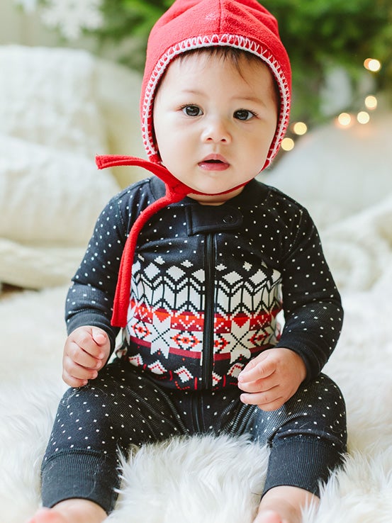 baby in black holiday pajamas