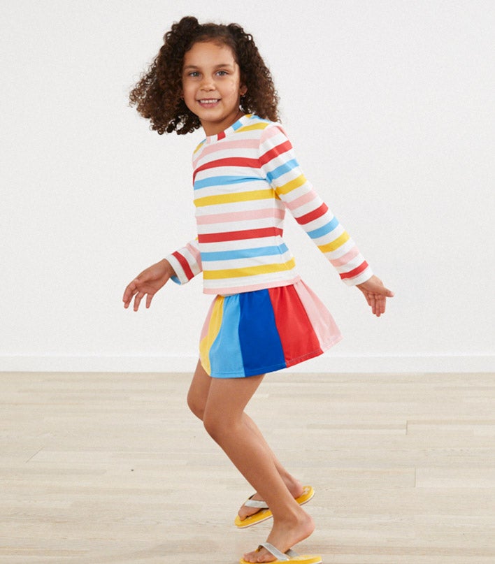 girl in stripe swim suit long sleeve and shorts