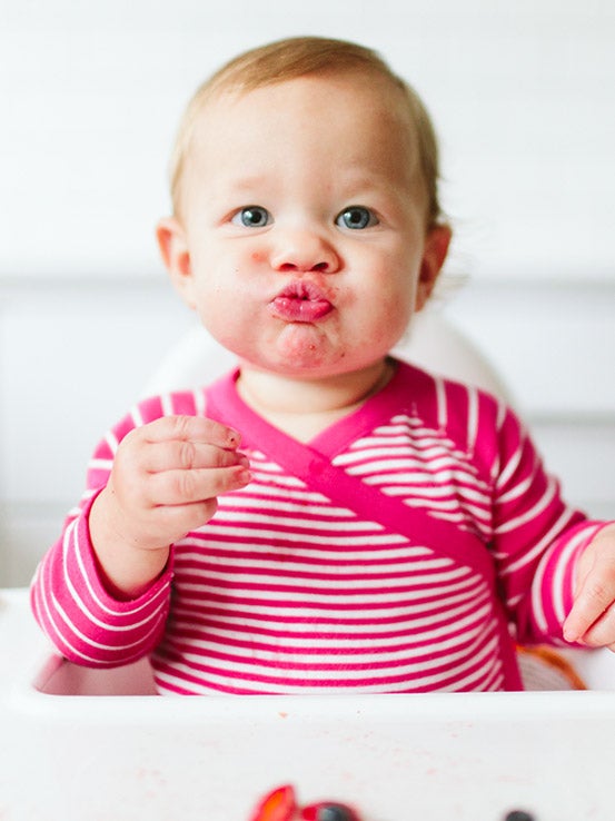 baby in pink and white sleeper