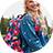 Girl in denim jacket with floral backpack